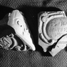 Vier zusammengehörige Fragmente aus der Grabung 1989. Kalkstein. Marienmonogramm (I) und Inschrift (II). 2003 nicht auffindbar.