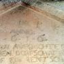 Bauinschrift auf einer dreieckigen Tafel an der Südostwand der Kapelle.